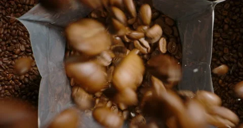 Close up of fresh roasted coffee beans packing process. Concept of keep fresh Stock Footage 237930112