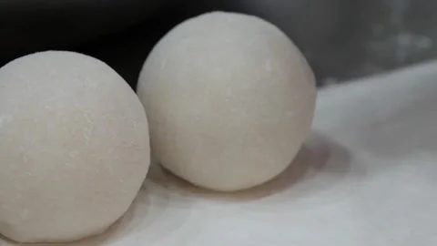 Close-Up of Fresh Round White Dough Balls on a Flour-Dusted Table Stock Footage 345291910