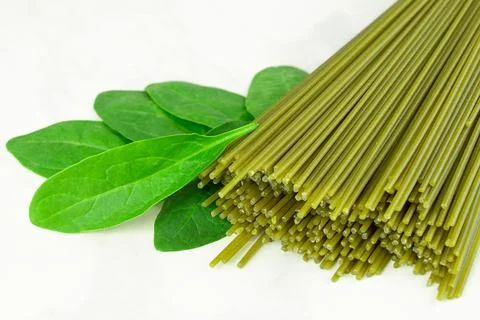 Close up Fresh spaghetti with spinach leaf on gray background Stock Photos