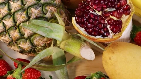 Close Up of Fresh Strawberries Pineapple and Open Pomegranate Display Stock Footage 329144191