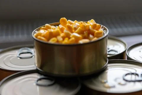 Close-up of fresh sweet corn in a partially open tin can with pull-tab Stock Photos