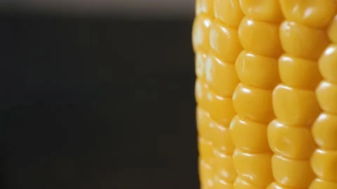 Close-up of fresh sweet yellow corn rotating smoothly Video stock 195006997