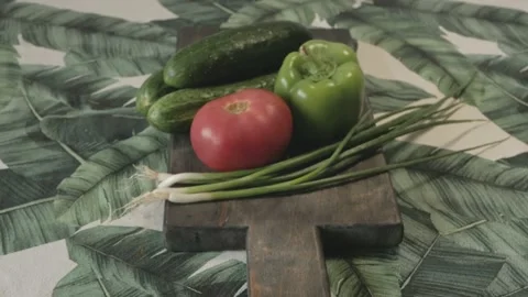 Close up of fresh tomato cucumber bell pepper and onion on cutting board Stock Footage 134068859