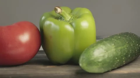 Close up of fresh tomato cucumber bell pepper on cutting board Stock Footage 134068880