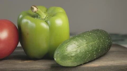 Close up of fresh tomato cucumber bell pepper on cutting board Stock Footage 134068882