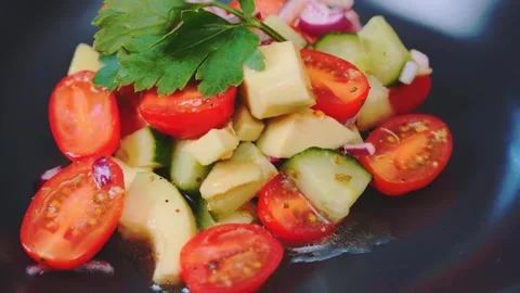 Close-up of fresh vegetable salad served on dark plate indoors 库存影片 342823567