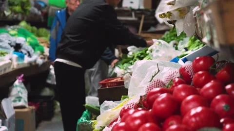 Close-up of fresh vegetables and tomatoes at a local market stall in Beijing Stock Footage 334965550