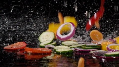 Close up of fresh vegetables falling with water in slow motion 動画素材 89341810