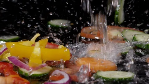 Close up of fresh vegetables falling with water in slow motion 動画素材 89342067