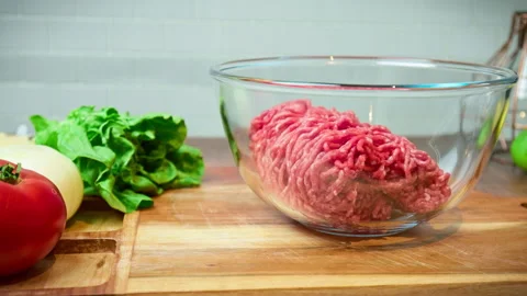 Close-up fresh vegetables on the table with grind beef mince in 4K. Video stock 153722533