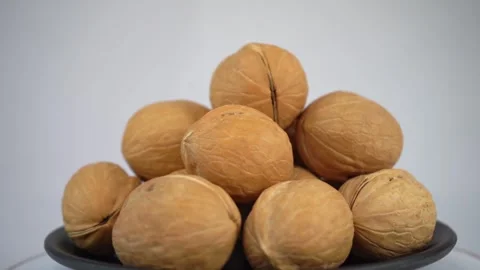 Close up of fresh walnut is rotating in black plate Stock Footage 293995133