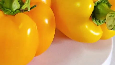 Close-up of fresh yellow bell pepper with green stem. Stock Footage 340938093