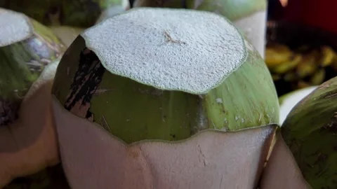 Close Up of Fresh Young Green Coconut Ready for Drinking at Tropical Market Stock Footage 337227419