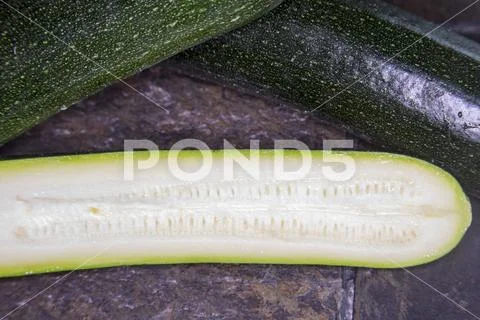 Close up of fresh zucchini or courgette slice Stock Photos
