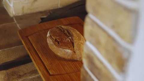 Close up of freshly baked aromatic loaf of wholemeal rye bread in rustic bakery Stock Footage 279230448