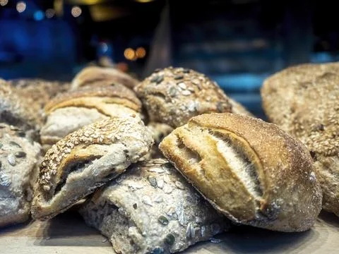 Close-up of freshly baked bread buns covered by pumpkin seeds Stock Photos