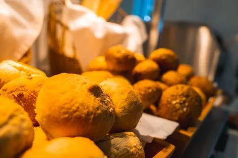 Close Up of Freshly Baked Bread Rolls in Wooden Tray with Breadsticks 스톡 사진