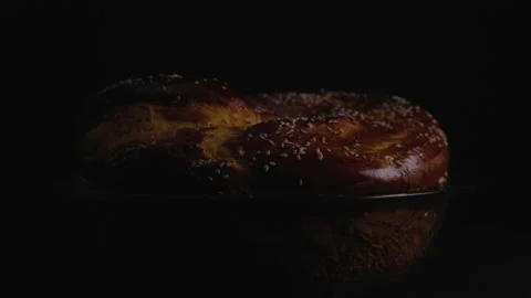 Close-up, Freshly Baked Bread Spins on The Turning Table on a Black Face Stock Footage 147740141