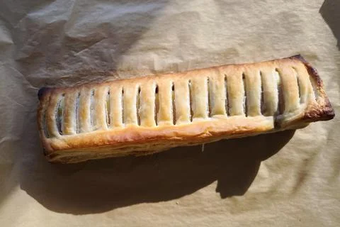 A close-up of a freshly baked rectangular pastry,, possibly an apple strudel Stock Photos
