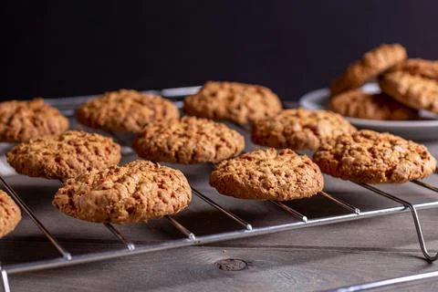 Close-up of a freshly baked stack of warm oatmeal cookies on a cooling rack a Stock Photos