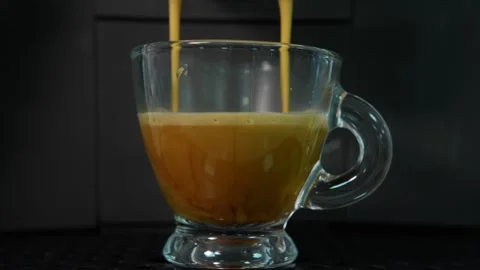 Close-up of freshly brewed espresso pouring into a transparent glass cup Stock Footage 342325813