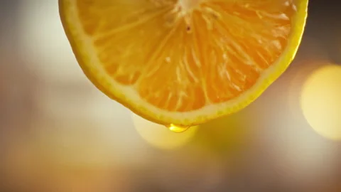 Close-up freshly cut lemon reveals intricate fibers seeds with single drop o Stock Footage 331348553