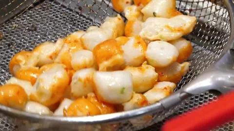 Close Up of Freshly Fried Korean Fish Cakes on a Strainer Stock Footage 337372918