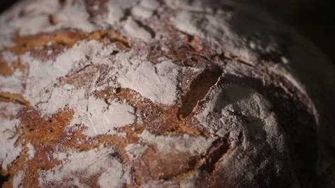 Close-up of a freshly made, warm and steamy organic bread loaf with flour crust. Stock Footage 145973290