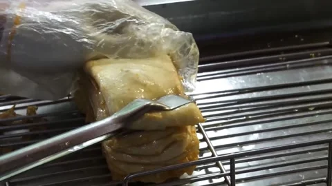 Close-up of freshly prepared Korean fish cake (Eomuk) on a metal cooling rack at Stock Footage 337374868