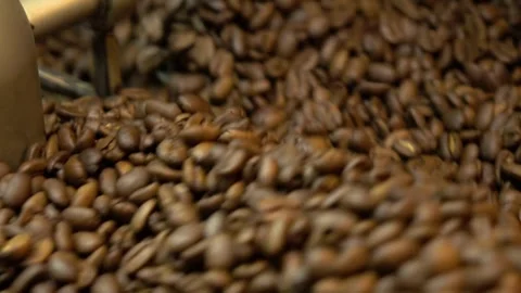 Close-up freshly roasted coffee beans from a large coffee roaster in mixing.. Stock Footage 272456453