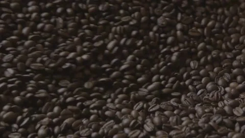 Close-up freshly roasted coffee beans from a large coffee roaster in mixing.. Stock Footage 272456507