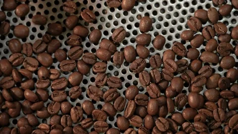 Close-up freshly roasted coffee beans from a large coffee roaster in mixing.. Stock Footage 272457935