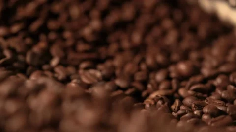 Close-up freshly roasted coffee beans from a large coffee roaster in mixing.. Stock Footage 272458269