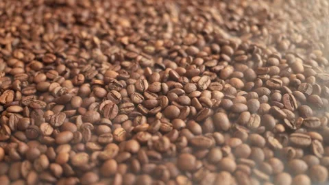 Close-up of freshly roasted coffee beans with steam rising, a sensory delight Stock Footage 338431301