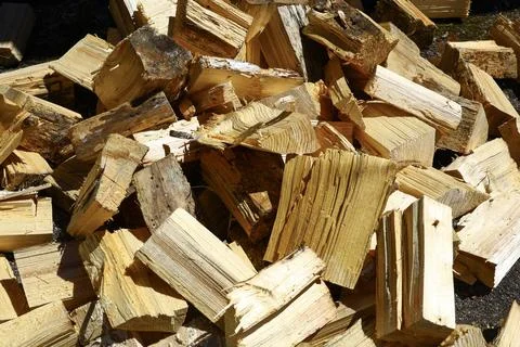 Close-up of freshly split firewood pieces stacked together outdoors Stock Photos
