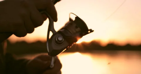 Close-up of friction reel fishing rod on the background of a beautiful sunset. Stock Footage
