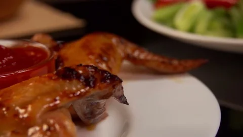 Close up of fried chicken wings dipped in ketchup Stock Footage 70469116