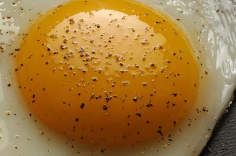 Close up of fried egg with pepper Stock Photos