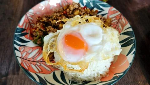 Close up fried egg in Thai cooking style over Stir fried minced beef Stock Photos