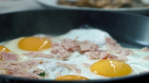 Close up fried eggs or omelette and with meat in kitchen frying pan Stock-Footage 204070425