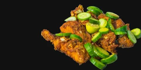 Close up of fried fish with lemon and cucumber. Stock Photos