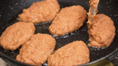 Close up fried juicy fish cutlets in frying pan. Hand flips 스톡 동영상 144738686