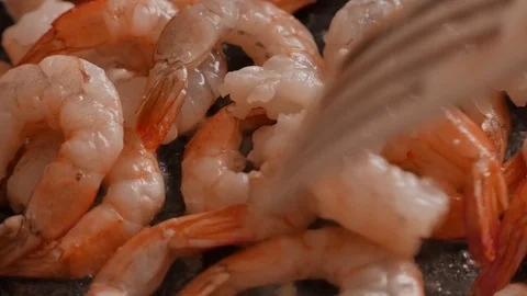 Close up of fried large prawns in a frying pan with oil. 4K UHD Stock Footage