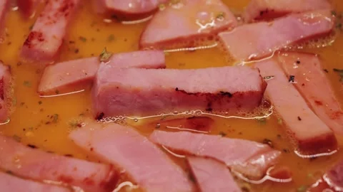 Close-up of fried sausages and eggs on a plate. Hearty homemade breakfast. Stock Footage 336681470