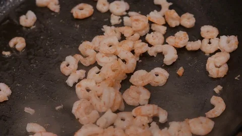 Close up of fried shrimps with eggs in a frying pan with oil. 4K UHD Stock Footage 73189577