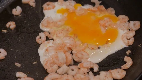 Close up of fried shrimps with eggs in a frying pan with oil. 4K UHD Stock Footage 73189808