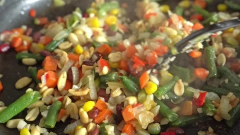 Close-up of fried vegetables being cooked in a frying pan. Stock Footage 317220399