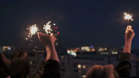 Close up of friends hands with bengal or sparkling lights. They waving hands Stock Footage 109090546