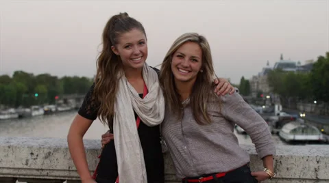 Close up of friends posing for photograph on bridge / Paris, France Stock Footage 38866672