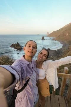 Close-Up, Front Angle Capture of a Couple Sunset Selfie Overlooking a Scenic Oce 写真素材